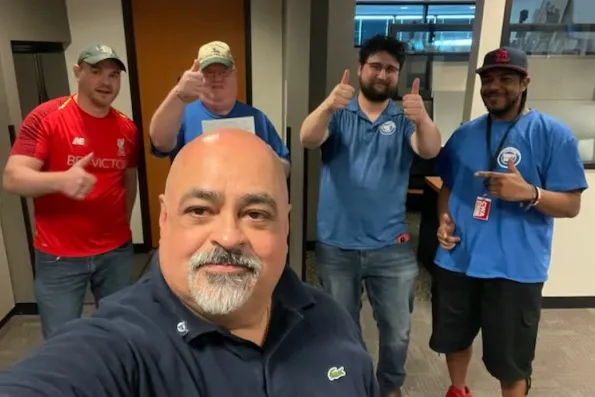 NABET-CWA Local 57052 NABET President Gil Maestas (foreground) poses with victorious KDVR workers. Organizing Coordinator Bera Dunau poses in the background with two thumbs up as they celebrate this high-profile organizing win.