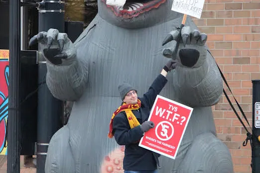 Local 54048 members picket in front of Gray Media/WNEM-TV station along with giant inflatable rat