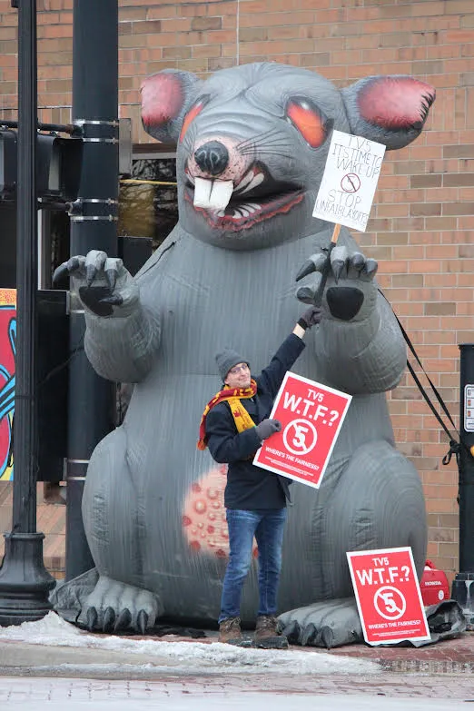 Local 54048 members picket in front of Gray Media/WNEM-TV station along with giant inflatable rat